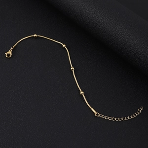 Detail of gold snake chain bracelet with polished beads and adjustable lobster clasp