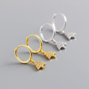 Detail shot of gold and silver Christmas tree earrings with sparkling zircon inlay