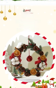 Detail of Christmas wreath with pine cones, dried orange slices and red bell decoration