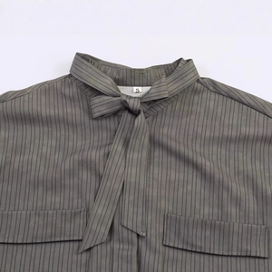 Fashionable grey green striped women's shirt featuring a bow neckline and pocket detail