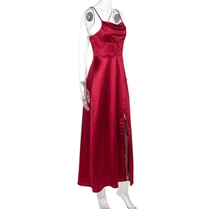 Detail of red satin evening dress featuring a high side slit and elegant cowl neckline