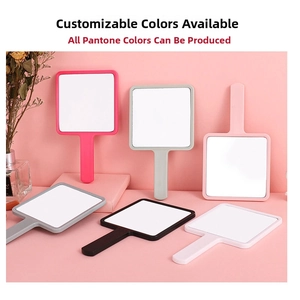 Square handheld makeup mirrors in multiple colors displayed on a pink decorative surface