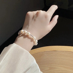 Elegant baroque freshwater pearl bracelet with silver beads on a female wrist