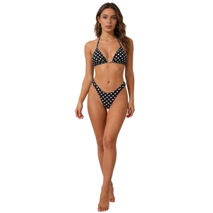Women's black and white polka dot bikini set with halter top and high cut bottoms