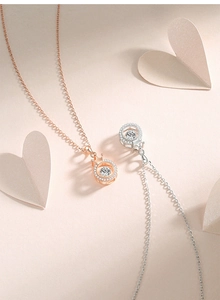 Detailed view of crown pendant necklaces in rose gold and silver with dancing stone