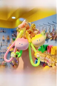 Close-up of pink and yellow resin tulip keychains with colorful silicone wrist straps