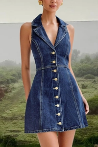 Detailed view of dark blue denim dress featuring gold buttons and a halter neckline