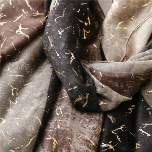 Detail of soft winter shawl showing gold foil prism texture on color-block fabric