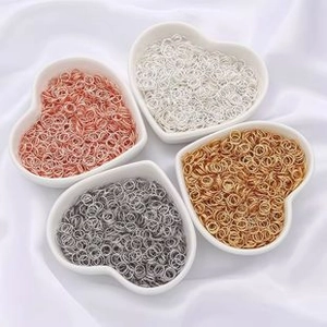 DIY jewelry connectors in four metallic colors displayed in heart-shaped white ceramic bowls
