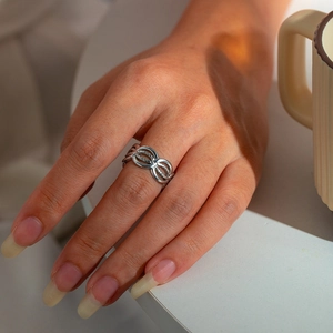 Close-up of woman wearing a 304 stainless steel infinity design ring in silver finish
