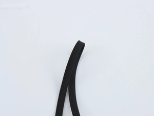 Detail shot of the black fabric shoulder strap with fine stitching on an elegant dress