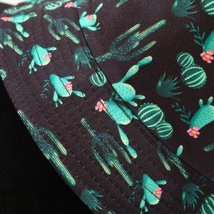 Close-up of bucket hat fabric showing green cactus patterns and detailed brim stitching