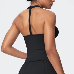 Detail of a black sports bra featuring a unique T-shaped back strap and sleek fit