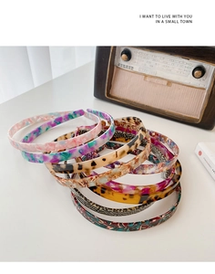 Detail of assorted tortoiseshell and patterned acetate headbands in various colors