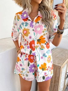 Detail of bohemian two-piece set featuring colorful floral print shirt and drawstring shorts