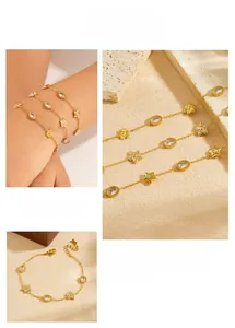 Detail of gold flower and star charms with crystals on a delicate stainless steel chain