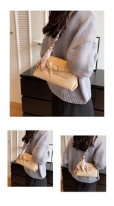 Detail of beige crossbody bag with lychee texture and heart pattern silk scarf strap