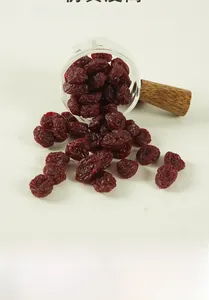 Macro shot of realistic deep purple PVC dried cranberry models spilling from a glass jar