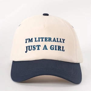 Macro view of blue embroidery text on a two-tone cotton twill baseball cap
