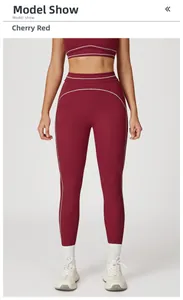 Detailed view of high-waist cherry red yoga leggings with white slimming side contours