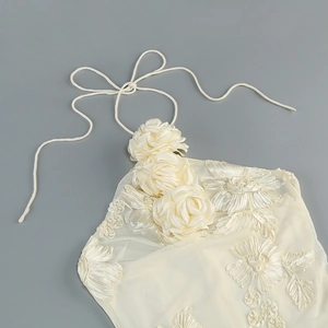 Detail of 3D rose decoration and embroidered lace mesh on the halter neck dress