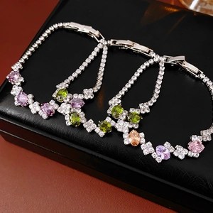 Detail of silver geometric bracelet with multi-colored cubic zirconia and clasp closure