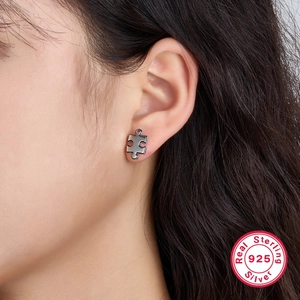 Minimalist S925 sterling silver puzzle piece stud earrings worn by model for daily style
