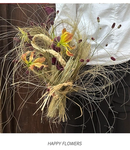 Artistic dried bouquet with yellow lilies, calla lilies and raffia grass tie detail