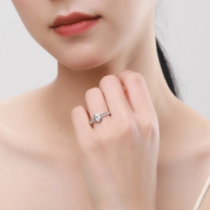 Minimalist sterling silver chain ring with oval zircon on a hand, professional close-up
