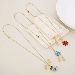 Detailed close-up of flower-shaped necklaces and stud earrings set in gold and crystal
