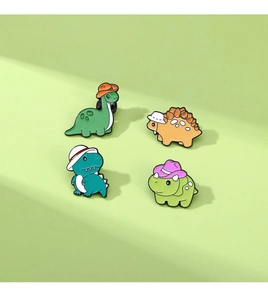 Collection of four cute cartoon dinosaur enamel pins on a light green background