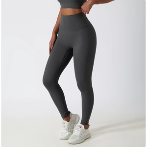 Detail of high-waisted dark grey yoga leggings with booty lifting and tummy control design