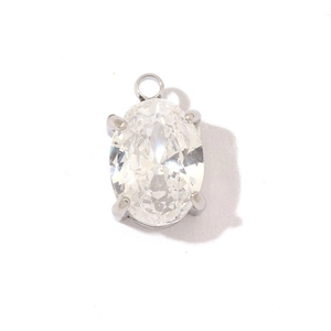 Close-up of silver stainless steel pendant with oval clear gemstone in 4-prong setting