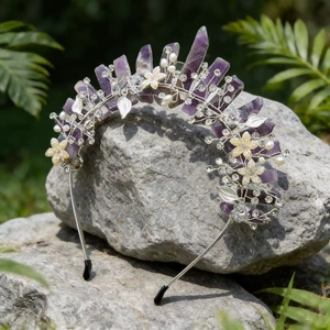 Detail of amethyst crystal crown with pearls and floral rhinestones on a rock