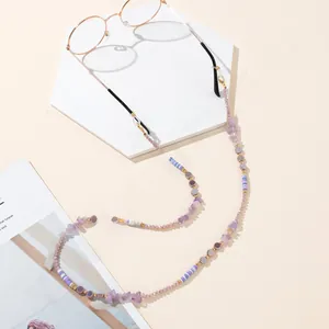 Detail of purple beaded eyewear chain with clay discs and gold lobster clasps