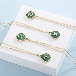 Mirror polished gold zodiac necklaces with green malachite texture and crystals