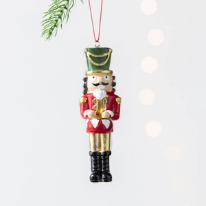 Classic Nutcracker Christmas resin ornament with red uniform and gold accents for holiday trees