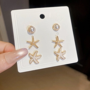 Detail view of 6-piece starfish and pearl stud earring set with gold plating and enamel finish