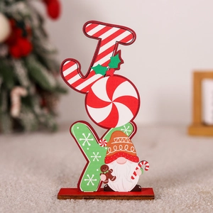 Close-up of wooden JOY letters featuring festive stripes, snowflake patterns and a gnome