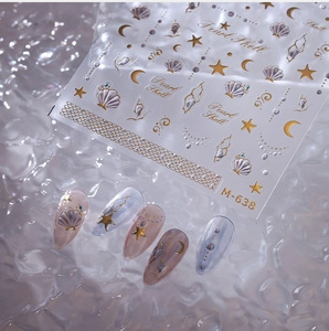 Macro shot of M-638 Pearl Shell nail stickers featuring gold and silver foil star patterns