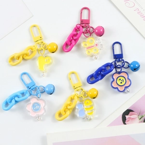 Macro shot of colorful plastic chain keychains with cartoon duck and bee pendants