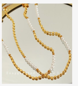 Macro detail of gold geometric beads and white pearls on a vintage necklace