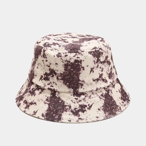 Neutral tie-dye bucket hat with brown splatter pattern on canvas for sun protection