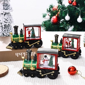 Three festive Santa and Snowman water-filled train ornaments on a Christmas tabletop