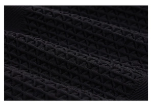 Detailed macro view of black waffle texture fabric on men's compression fitness t-shirt