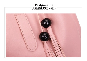 Detail of pink faux leather bag showing retro litchi texture and stylish bead tassel charm