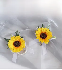 Detailed view of sunflower boutonniere and wrist corsage with pearls for wedding guests