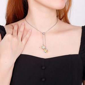 Silver stainless steel necklace with crystal spheres on model against white background