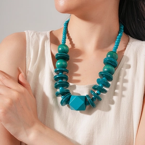 Close-up of bohemian wood and coconut shell beaded necklace with geometric pendant