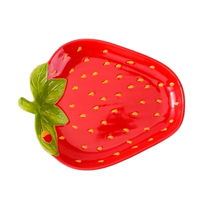 Creative strawberry shaped ceramic plate in vibrant red with realistic green leaf detail